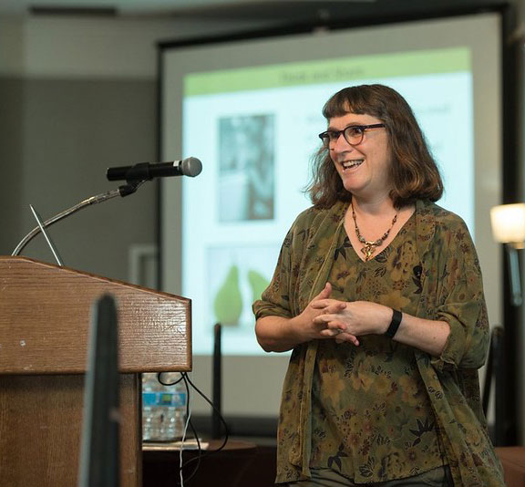 Beth speaking at a podium