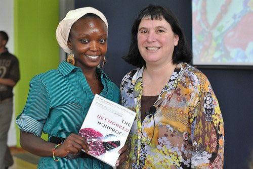 Beth posing with a fan and a copy of her book The Networked Nonprofit